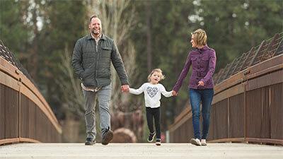 Parents walking their child